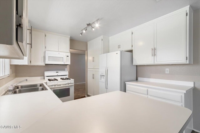 2130 Candice Ave, Rosamond, CA 93560 - kitchen with white appliances, light countertops, white cabinets, and a peninsula