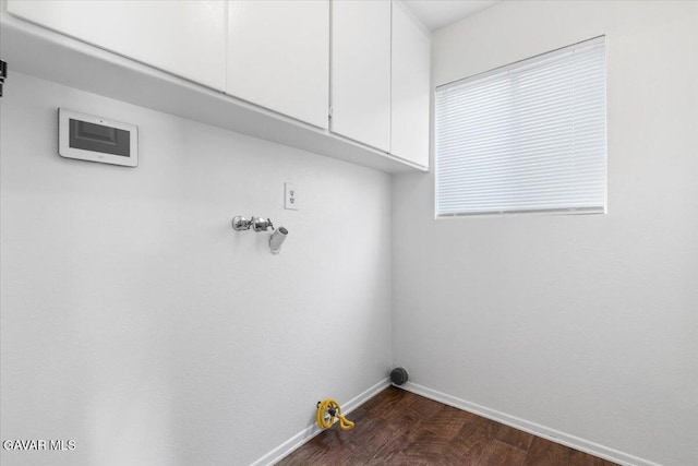 2130 Candice Ave, Rosamond, CA 93560 - laundry room with cabinet space, dark wood-style flooring, and hookup for a washing machine