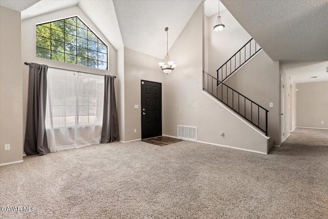 2130 Candice Ave, Rosamond, CA 93560 - carpeted entrance foyer with a textured ceiling, a chandelier, stairs, and high vaulted ceiling