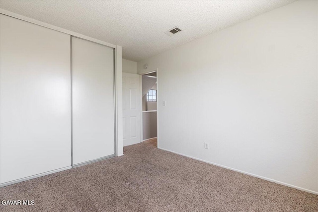 2130 Candice Ave, Rosamond, CA 93560 - unfurnished bedroom with carpet floors, a closet, and a textured ceiling