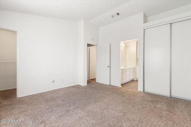 2130 Candice Ave, Rosamond, CA 93560 - unfurnished bedroom with carpet, a closet, ensuite bath, a textured ceiling, and high vaulted ceiling