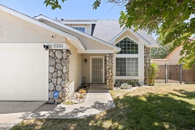 2130 Candice Ave, Rosamond, CA 93560 - entrance to property featuring stone siding, an attached garage, stucco siding, and roof with shingles