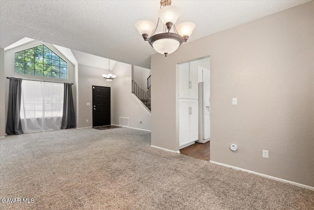 2130 Candice Ave, Rosamond, CA 93560 - carpeted spare room featuring a chandelier, stairs, vaulted ceiling, and a textured ceiling