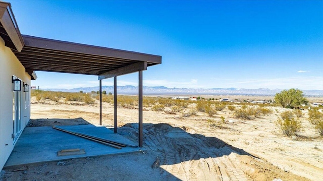 view of yard featuring a carport and a mountain view