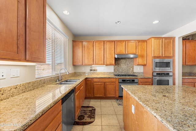 41507 Alexo Dr, Lancaster, CA 93536 - kitchen featuring stainless steel appliances, under cabinet range hood, light stone counters, tasteful backsplash, and recessed lighting