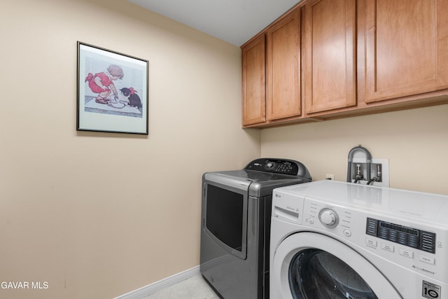 41507 Alexo Dr, Lancaster, CA 93536 - washroom featuring separate washer and dryer and cabinet space