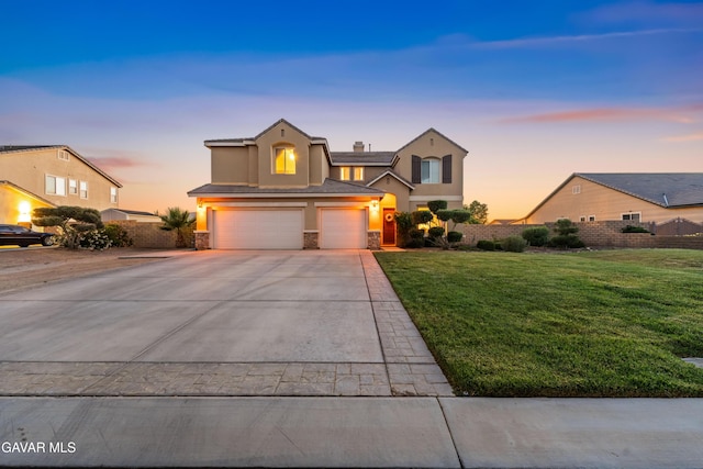 41507 Alexo Dr, Lancaster, CA 93536 - traditional-style home with stucco siding, a garage, concrete driveway, and stone siding