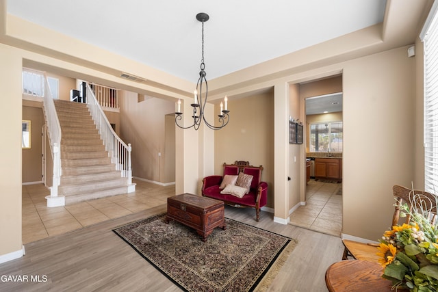 41507 Alexo Dr, Lancaster, CA 93536 - sitting room with light wood-style floors, stairway, and a chandelier