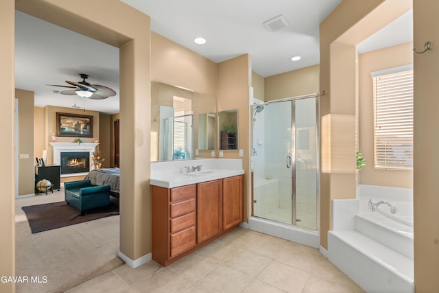 41507 Alexo Dr, Lancaster, CA 93536 - ensuite bathroom featuring a stall shower, vanity, a garden tub, a ceiling fan, and a glass covered fireplace
