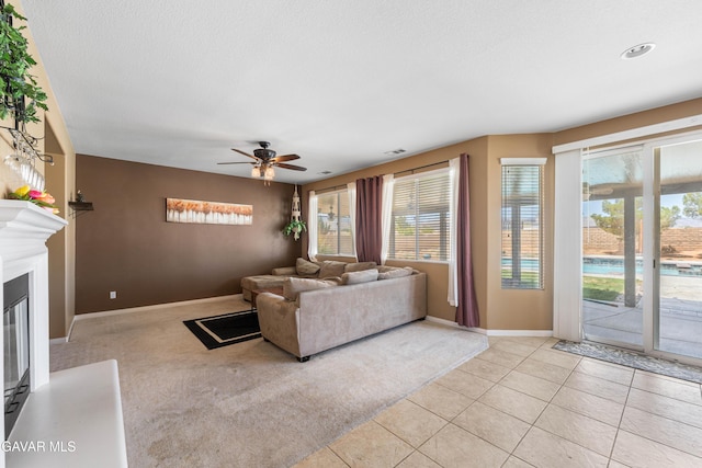 41507 Alexo Dr, Lancaster, CA 93536 - living area featuring plenty of natural light, ceiling fan, a glass covered fireplace, and light tile patterned floors