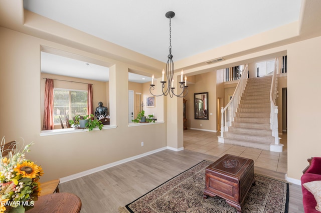 41507 Alexo Dr, Lancaster, CA 93536 - living area featuring stairs, a chandelier, and wood finished floors