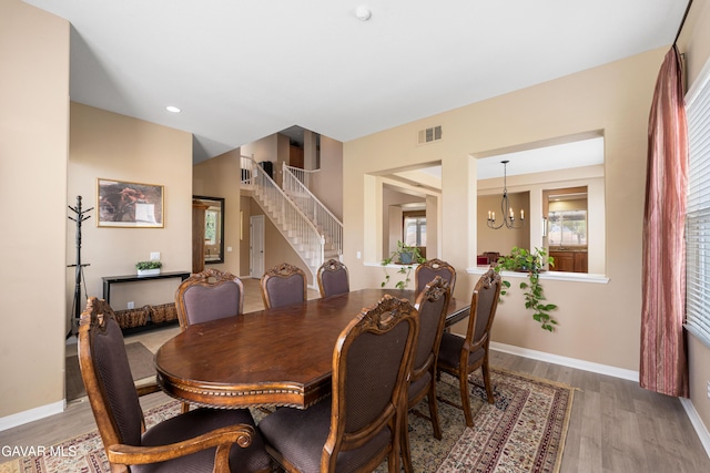 41507 Alexo Dr, Lancaster, CA 93536 - dining area with wood finished floors, stairs, a chandelier, and recessed lighting