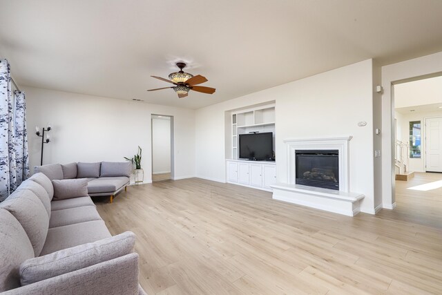 sitting room featuring a high ceiling and light wood-type flooring