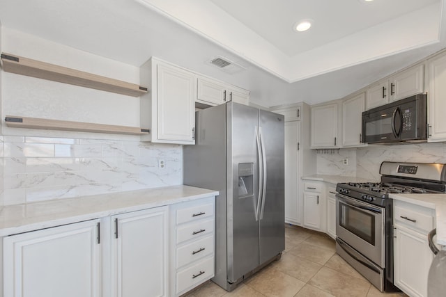 kitchen with stainless steel appliances, visible vents, decorative backsplash, open shelves, and a raised ceiling