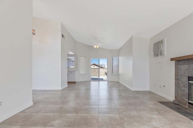 unfurnished living room featuring a ceiling fan, a tile fireplace, visible vents, and baseboards