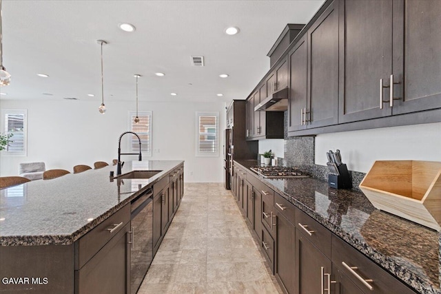 39057 Mondell Pine Ave, Palmdale, CA 93551 - kitchen featuring under cabinet range hood, dark stone counters, dark brown cabinetry, and recessed lighting