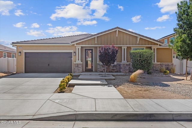 39057 Mondell Pine Ave, Palmdale, CA 93551 - view of front facade featuring stone siding, concrete driveway, a garage, and board and batten siding