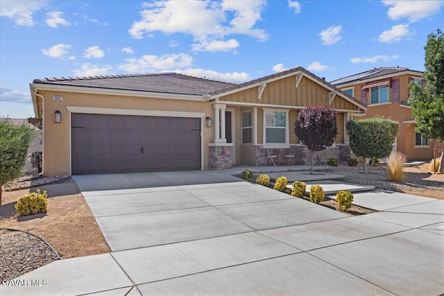 39057 Mondell Pine Ave, Palmdale, CA 93551 - view of front of property featuring a tile roof, concrete driveway, a garage, and stucco siding