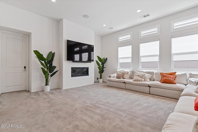 39057 Mondell Pine Ave, Palmdale, CA 93551 - living area featuring carpet flooring, a glass covered fireplace, and recessed lighting