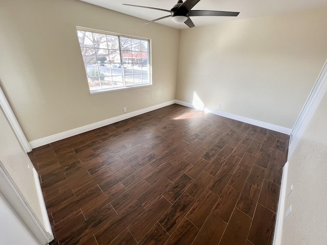 empty room featuring ceiling fan and dark hardwood / wood-style flooring