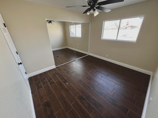 unfurnished bedroom with ceiling fan, dark hardwood / wood-style floors, and a closet