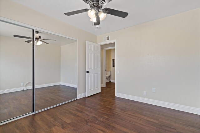 unfurnished room with dark wood-type flooring