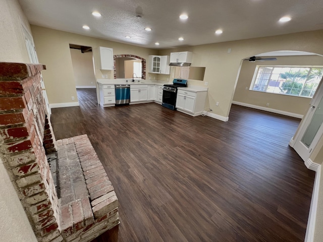 kitchen with ceiling fan, extractor fan, stainless steel appliances, white cabinets, and dark hardwood / wood-style flooring