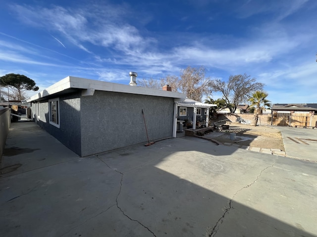 rear view of property featuring a patio area