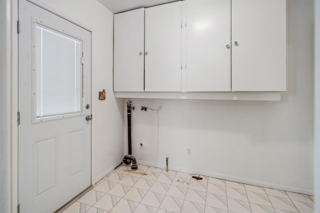 laundry area featuring electric dryer hookup and cabinets