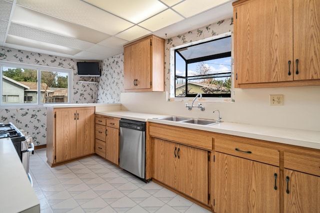 kitchen featuring sink, plenty of natural light, kitchen peninsula, and dishwasher