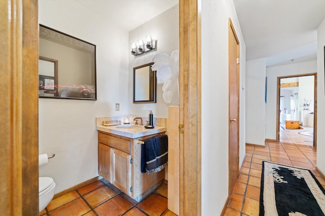 bathroom featuring tile patterned flooring, vanity, and toilet