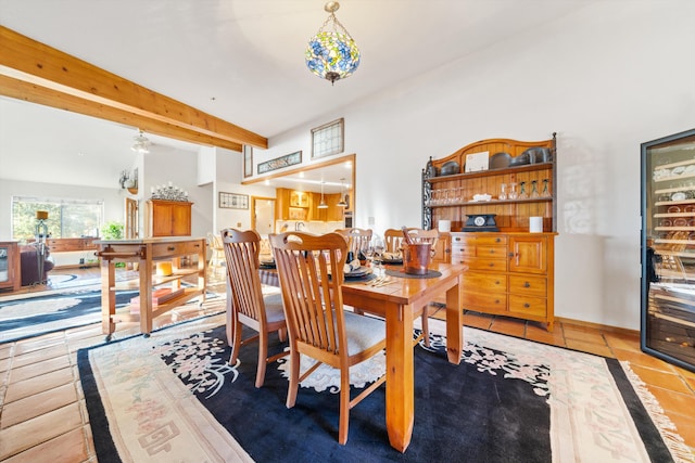 dining area with beam ceiling and tile patterned flooring