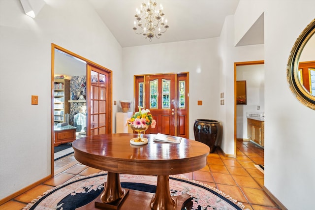 tiled dining area featuring plenty of natural light, vaulted ceiling, and an inviting chandelier