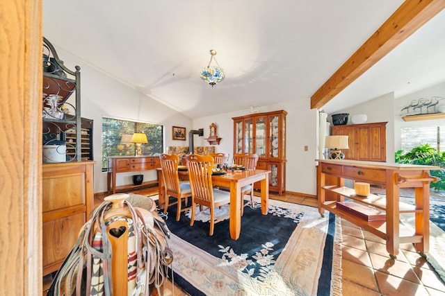 tiled dining area with vaulted ceiling with beams