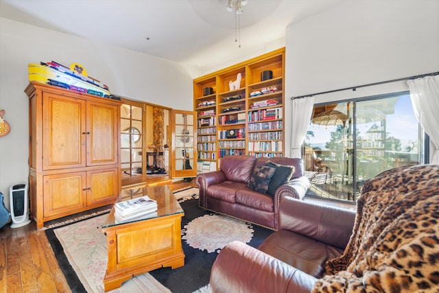 living room with ceiling fan and dark wood-type flooring