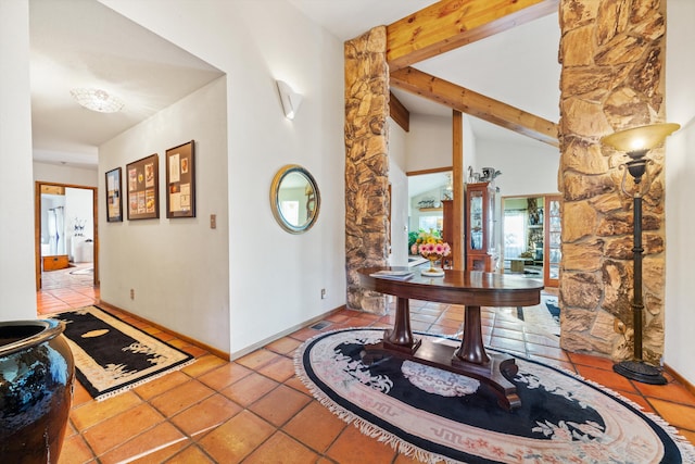 corridor with french doors, light tile patterned floors, and high vaulted ceiling