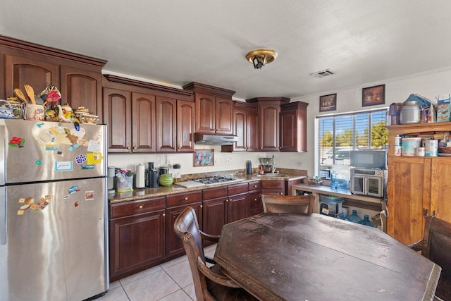 kitchen with light tile patterned flooring, sink, dark brown cabinets, ornamental molding, and stainless steel appliances