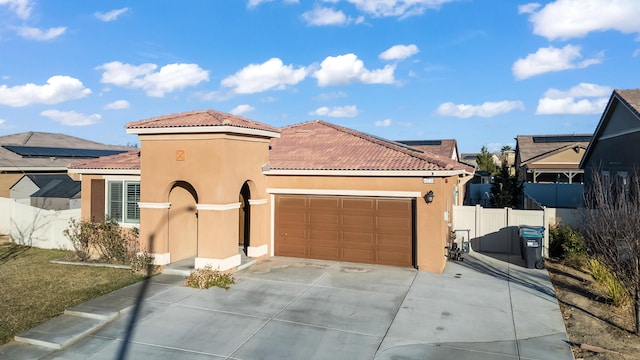 mediterranean / spanish-style home with a garage