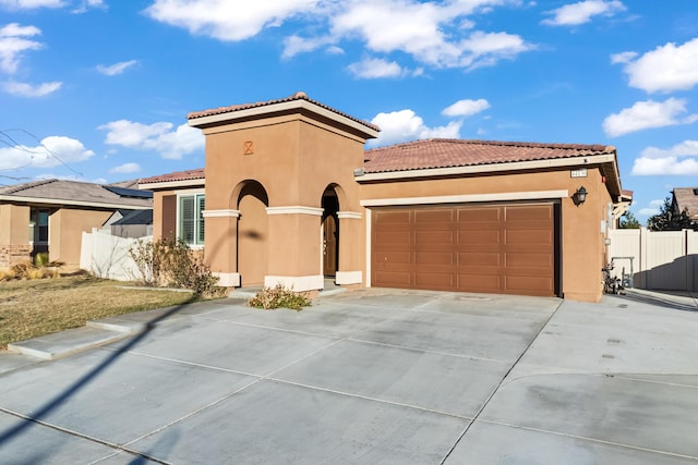 mediterranean / spanish-style house featuring a garage