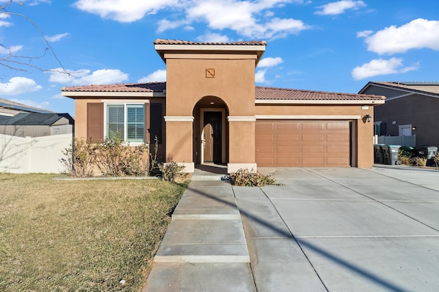 mediterranean / spanish home featuring a garage and a front yard