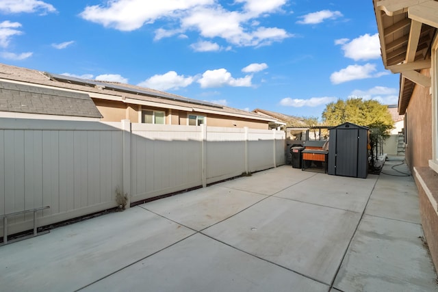 view of patio featuring a storage unit