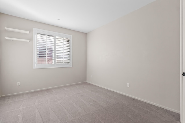 unfurnished room with light colored carpet