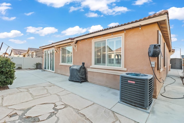 back of house with a patio and central air condition unit