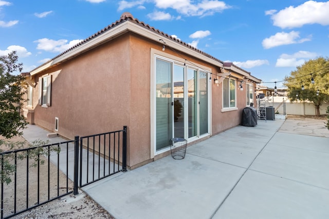 view of home's exterior with central air condition unit and a patio