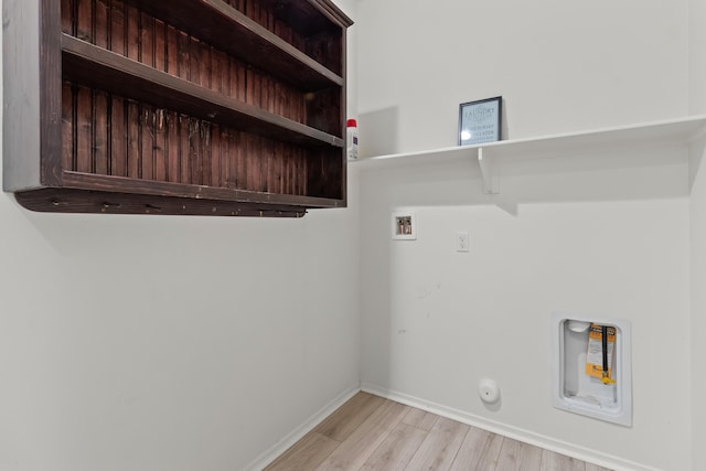 clothes washing area with gas dryer hookup, hookup for a washing machine, and light hardwood / wood-style floors