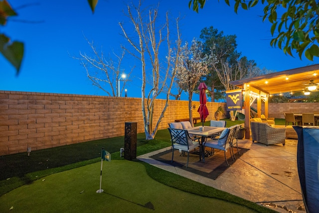 view of patio / terrace featuring outdoor dining space, a playground, and a fenced backyard