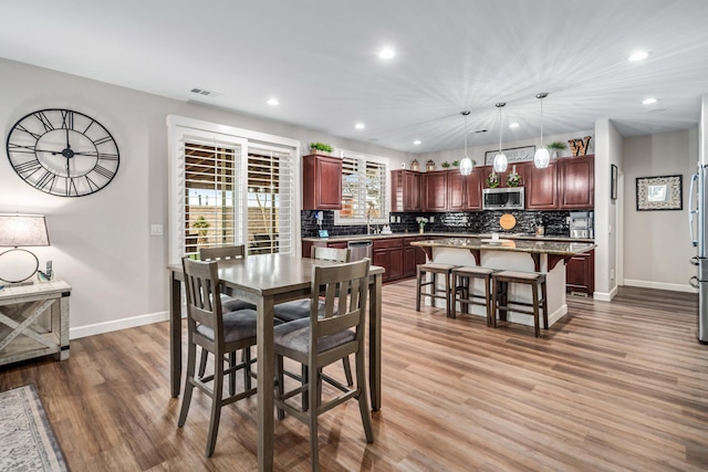 dining room with visible vents, recessed lighting, wood finished floors, and baseboards