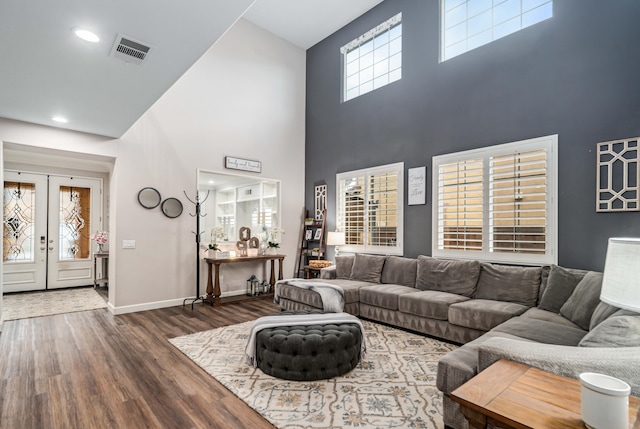 living room featuring wood finished floors, visible vents, baseboards, recessed lighting, and french doors