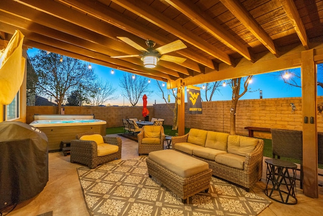 patio terrace at dusk featuring ceiling fan, area for grilling, a fenced backyard, and outdoor lounge area