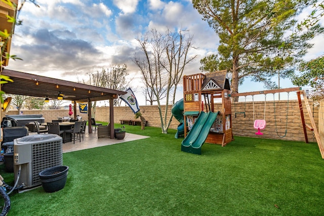 view of yard featuring a patio area, central AC unit, a playground, and a fenced backyard